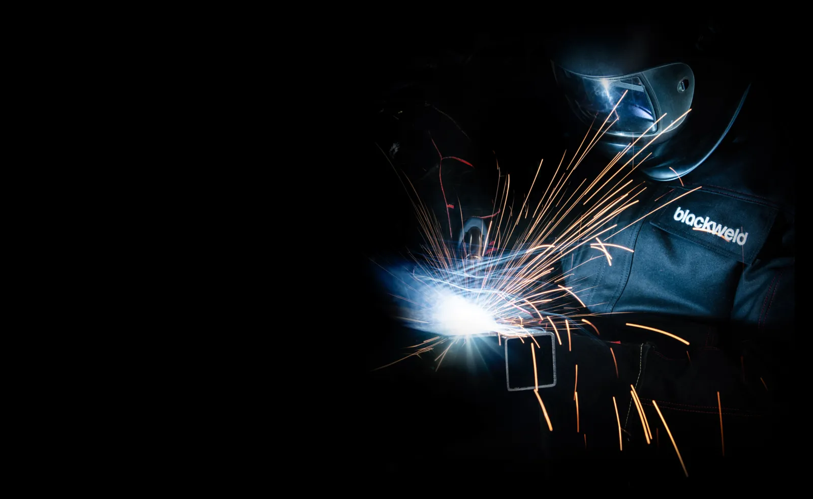 Schweißer in BLACKWELD-Schutzjacke beim MAG-Schweißen mit Funkenflug